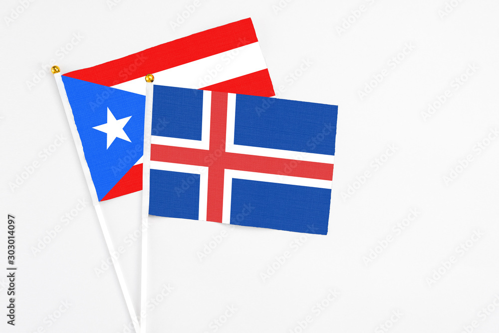 Iceland and Puerto Rico stick flags on white background. High quality fabric, miniature national flag. Peaceful global concept.White floor for copy space. Iceland and Puerto Rico stick flags on white background. High quality fabric, miniature national flag. Peaceful global concept.White floor for copy space.