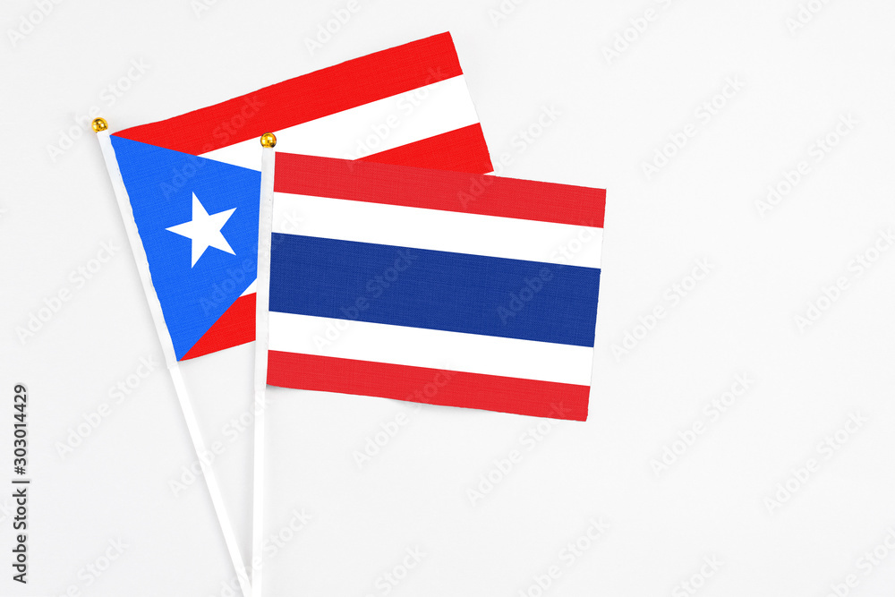 Thailand and Puerto Rico stick flags on white background. High quality fabric, miniature national flag. Peaceful global concept.White floor for copy space. Thailand and Puerto Rico stick flags on white background. High quality fabric, miniature national flag. Peaceful global concept.White floor for copy space.