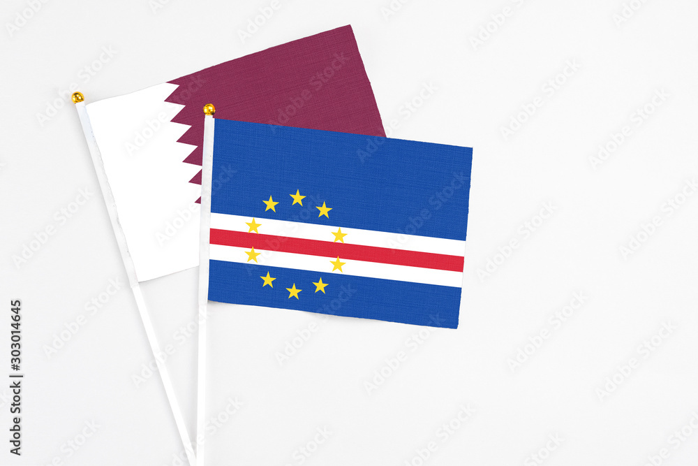 Cape Verde and Qatar stick flags on white background. High quality fabric, miniature national flag. Peaceful global concept.White floor for copy space. Cape Verde and Qatar stick flags on white background. High quality fabric, miniature national flag. Peaceful global concept.White floor for copy space.