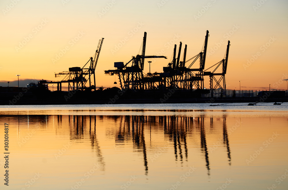 Maritime cranes in the port at sunrise