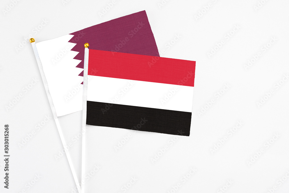 Yemen and Qatar stick flags on white background. High quality fabric, miniature national flag. Peaceful global concept.White floor for copy space. Yemen and Qatar stick flags on white background. High quality fabric, miniature national flag. Peaceful global concept.White floor for copy space.