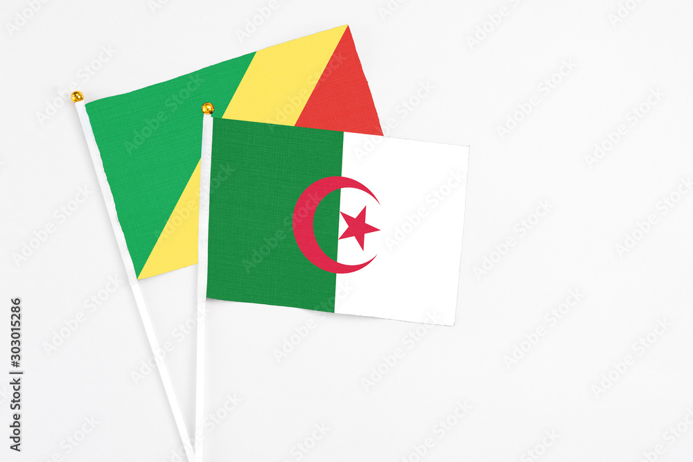 Algeria and Republic Of The Congo stick flags on white background. High quality fabric, miniature national flag. Peaceful global concept.White floor for copy space. Algeria and Republic Of The Congo stick flags on white background. High quality fabric, miniature national flag. Peaceful global concept.White floor for copy space.