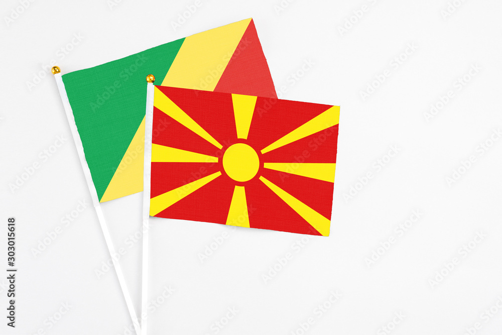Macedonia and Republic Of The Congo stick flags on white background. High quality fabric, miniature national flag. Peaceful global concept.White floor for copy space.