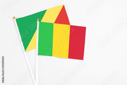 Mali and Republic Of The Congo stick flags on white background. High quality fabric, miniature national flag. Peaceful global concept.White floor for copy space.