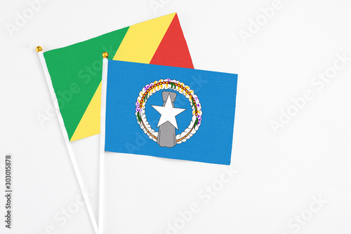 Free Download Northern Mariana Islands and Republic Of The Congo stick flags on white background. High quality fabric, miniature national flag. Peaceful global concept.White floor for copy space. - GFXLoad