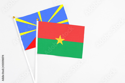 Burkina Faso and Reunion stick flags on white background. High quality fabric, miniature national flag. Peaceful global concept.White floor for copy space. Free Download Burkina Faso and Reunion stick flags on white background. High quality fabric, miniature national flag. Peaceful global concept.White floor for copy space. - GFXLoad