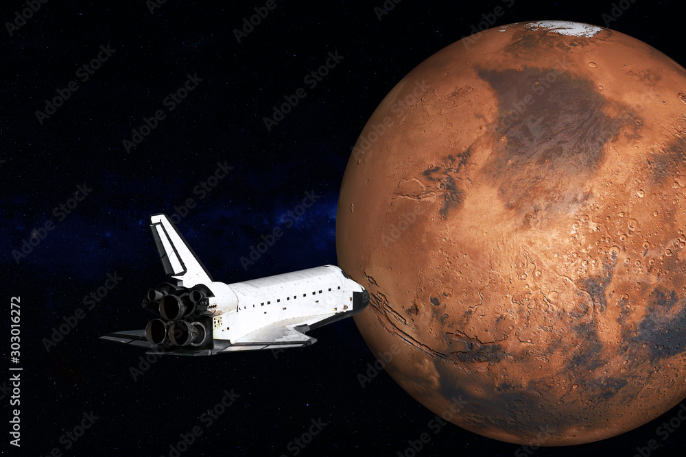 Flying space shuttle close to the Mars planet of Solar system. Mars colonization mission. Science fiction. Elements of the image are furnished by NASA