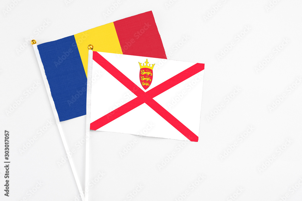 Jersey and Romania stick flags on white background. High quality fabric, miniature national flag. Peaceful global concept.White floor for copy space. Jersey and Romania stick flags on white background. High quality fabric, miniature national flag. Peaceful global concept.White floor for copy space.