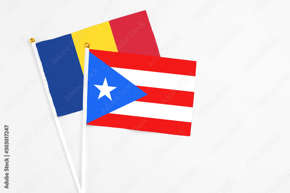 Puerto Rico and Romania stick flags on white background. High quality fabric, miniature national flag. Peaceful global concept.White floor for copy space. Puerto Rico and Romania stick flags on white background. High quality fabric, miniature national flag. Peaceful global concept.White floor for copy space.