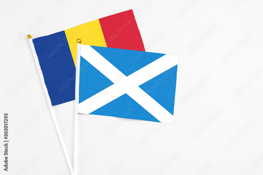 Scotland and Romania stick flags on white background. High quality fabric, miniature national flag. Peaceful global concept.White floor for copy space. Scotland and Romania stick flags on white background. High quality fabric, miniature national flag. Peaceful global concept.White floor for copy space.
