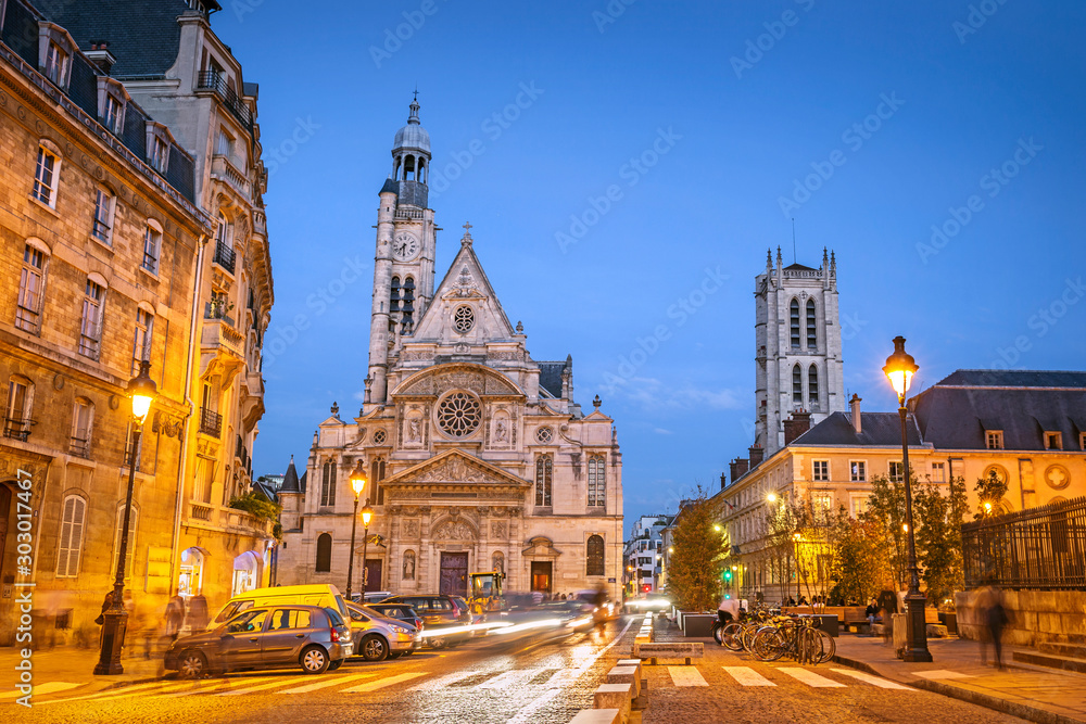 Illuminated streets of Paris during the blue hour in the evening, with Saint-Etienne-du-Mont church, Paris, France