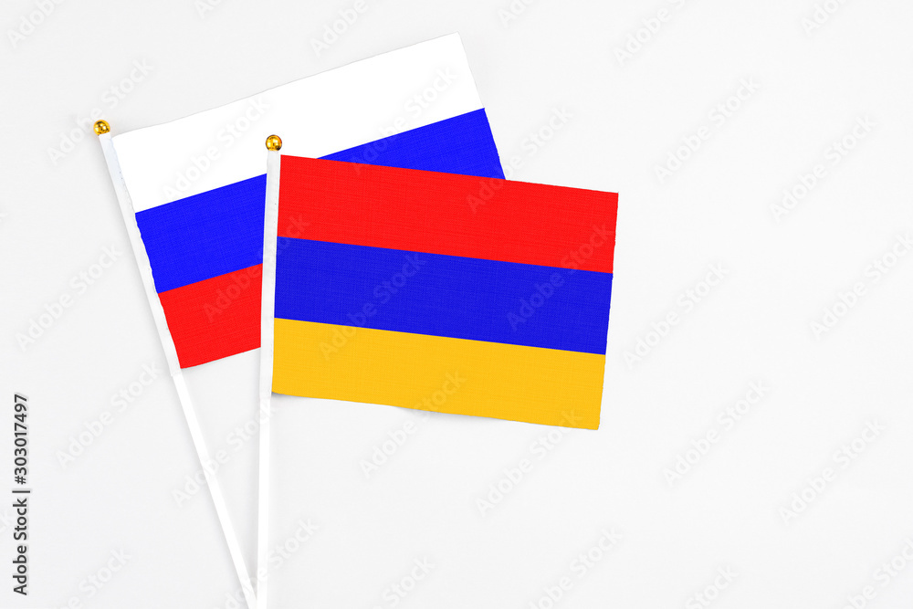 Armenia and Russia stick flags on white background. High quality fabric, miniature national flag. Peaceful global concept.White floor for copy space. Armenia and Russia stick flags on white background. High quality fabric, miniature national flag. Peaceful global concept.White floor for copy space.