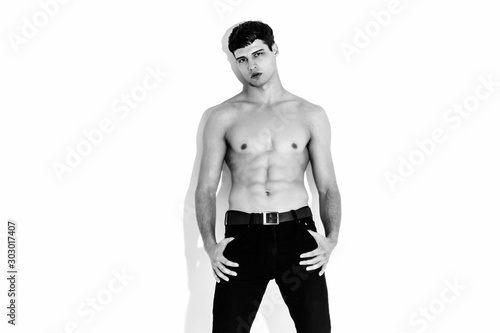 Black and White Muscle strong beautiful stripped male model in denim jeans on white isolated font background with shadow