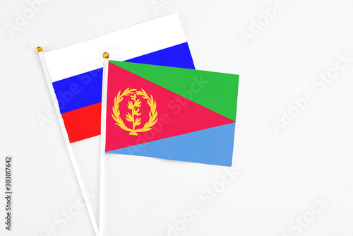 Free Download Eritrea and Russia stick flags on white background. High quality fabric, miniature national flag. Peaceful global concept.White floor for copy space. - GFXLoad