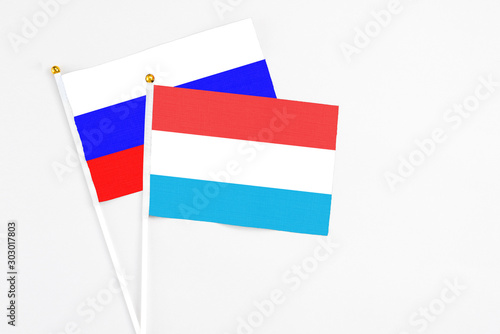 Luxembourg and Russia stick flags on white background. High quality fabric, miniature national flag. Peaceful global concept.White floor for copy space. Free Download Luxembourg and Russia stick flags on white background. High quality fabric, miniature national flag. Peaceful global concept.White floor for copy space. - GFXLoad