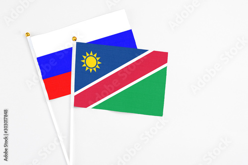 Free Download Namibia and Russia stick flags on white background. High quality fabric, miniature national flag. Peaceful global concept.White floor for copy space. - GFXLoad