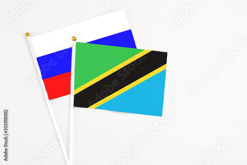 Free Download Tanzania and Russia stick flags on white background. High quality fabric, miniature national flag. Peaceful global concept.White floor for copy space. - GFXLoad