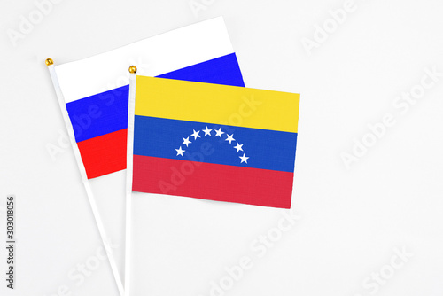Free Download Venezuela and Russia stick flags on white background. High quality fabric, miniature national flag. Peaceful global concept.White floor for copy space. - GFXLoad