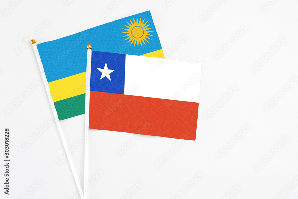 Chile and Rwanda stick flags on white background. High quality fabric, miniature national flag. Peaceful global concept.White floor for copy space. Chile and Rwanda stick flags on white background. High quality fabric, miniature national flag. Peaceful global concept.White floor for copy space.