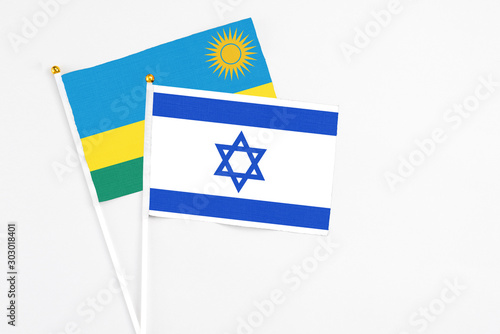 Free Download Israel and Rwanda stick flags on white background. High quality fabric, miniature national flag. Peaceful global concept.White floor for copy space. - GFXLoad