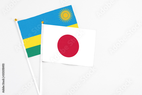 Japan and Rwanda stick flags on white background. High quality fabric, miniature national flag. Peaceful global concept.White floor for copy space. Free Download Japan and Rwanda stick flags on white background. High quality fabric, miniature national flag. Peaceful global concept.White floor for copy space. - GFXLoad
