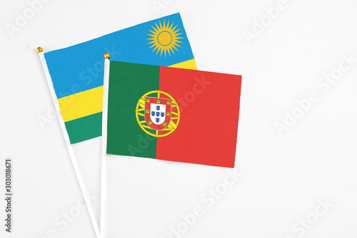 Portugal and Rwanda stick flags on white background. High quality fabric, miniature national flag. Peaceful global concept.White floor for copy space. Free Download Portugal and Rwanda stick flags on white background. High quality fabric, miniature national flag. Peaceful global concept.White floor for copy space. - GFXLoad