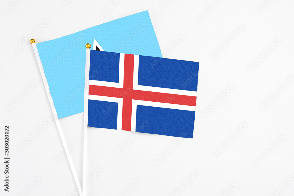Iceland and Saint Lucia stick flags on white background. High quality fabric, miniature national flag. Peaceful global concept.White floor for copy space. Iceland and Saint Lucia stick flags on white background. High quality fabric, miniature national flag. Peaceful global concept.White floor for copy space.