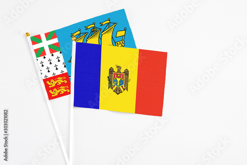 Moldova and Saint Pierre And Miquelon stick flags on white background. High quality fabric, miniature national flag. Peaceful global concept.White floor for copy space.