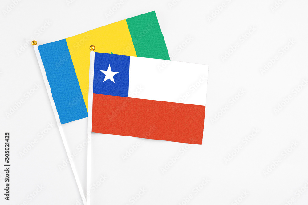 Chile and Saint Vincent And The Grenadines stick flags on white background. High quality fabric, miniature national flag. Peaceful global concept.White floor for copy space. Chile and Saint Vincent And The Grenadines stick flags on white background. High quality fabric, miniature national flag. Peaceful global concept.White floor for copy space.