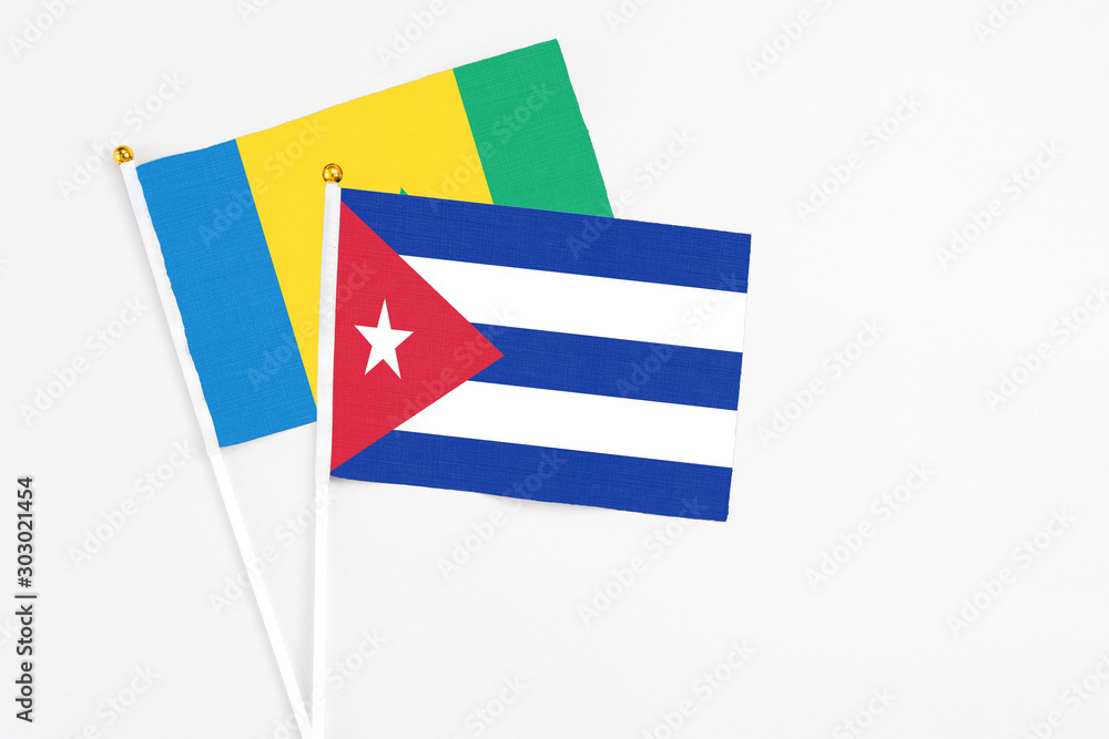 Obraz premium Cuba and Saint Vincent And The Grenadines stick flags on white background. High quality fabric, miniature national flag. Peaceful global concept.White floor for copy space.