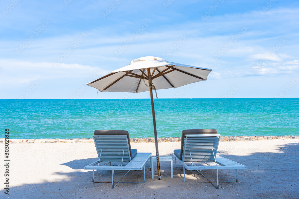 Beautiful umbrella and chair around beach sea ocean with blue sky for travel