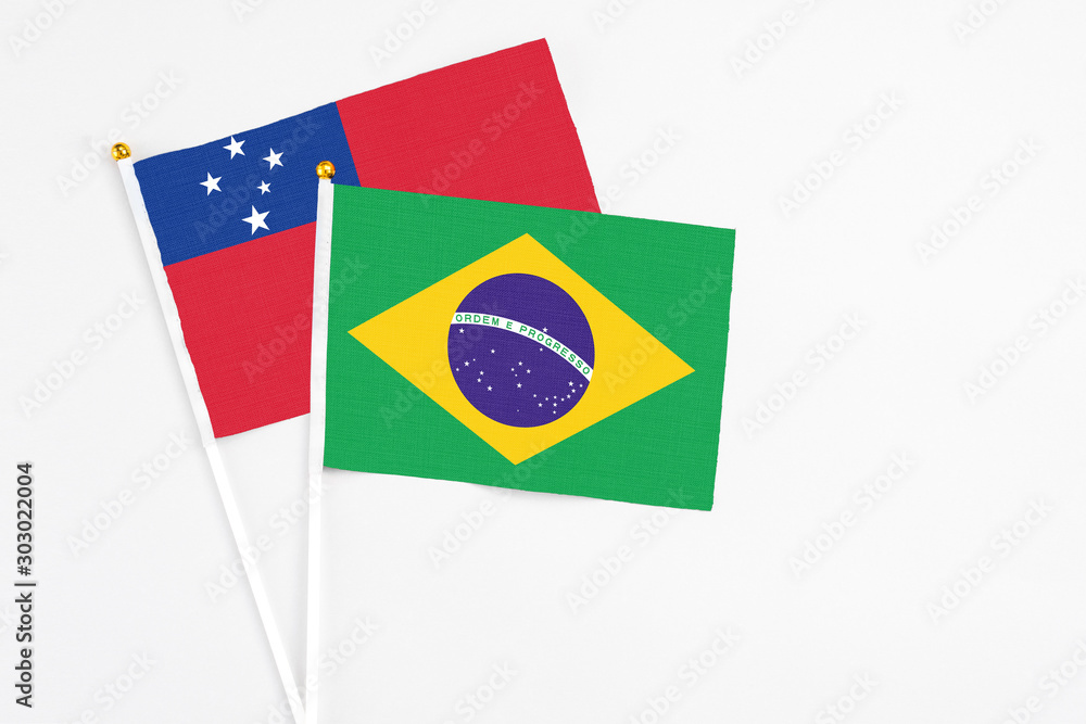 Brazil and Samoa stick flags on white background. High quality fabric, miniature national flag. Peaceful global concept.White floor for copy space.