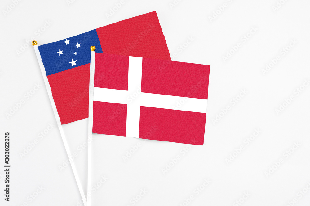 Denmark and Samoa stick flags on white background. High quality fabric, miniature national flag. Peaceful global concept.White floor for copy space.