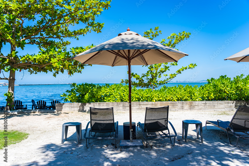 Umbrella and chair on the beach and sea with blue sky