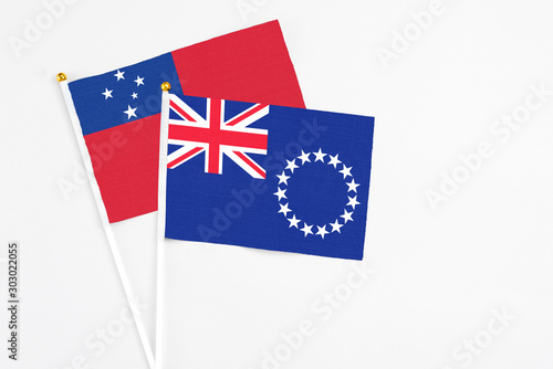 Cook Islands and Samoa stick flags on white background. High quality fabric, miniature national flag. Peaceful global concept.White floor for copy space.