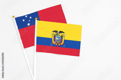 Ecuador and Samoa stick flags on white background. High quality fabric, miniature national flag. Peaceful global concept.White floor for copy space.