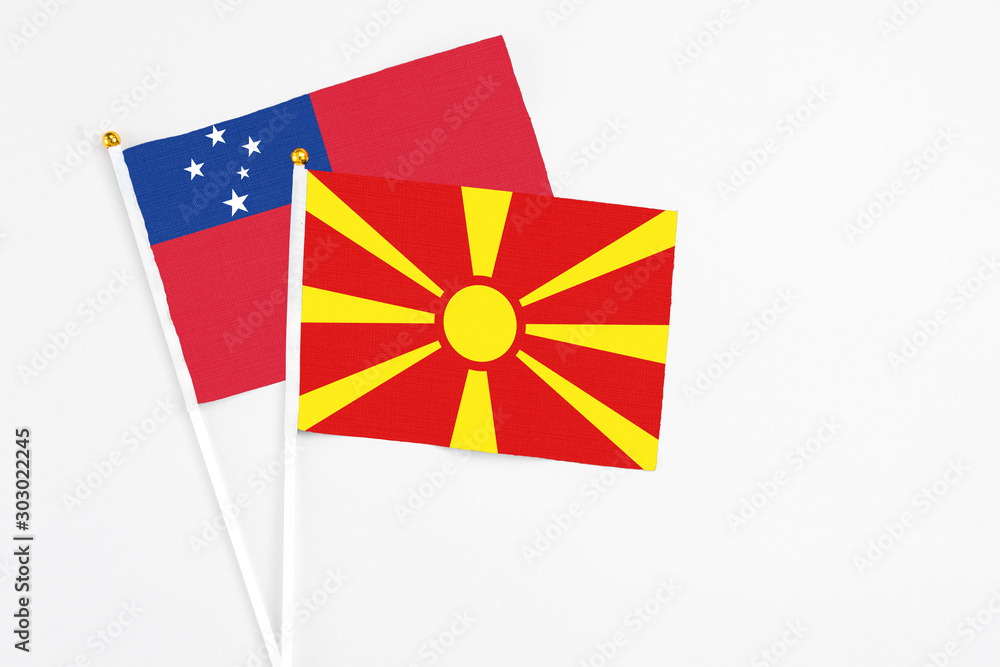Macedonia and Samoa stick flags on white background. High quality fabric, miniature national flag. Peaceful global concept.White floor for copy space.