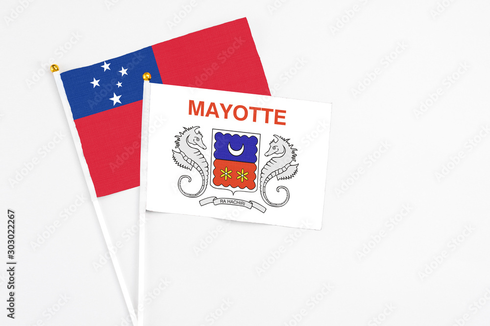 Mayotte and Samoa stick flags on white background. High quality fabric, miniature national flag. Peaceful global concept.White floor for copy space. Mayotte and Samoa stick flags on white background. High quality fabric, miniature national flag. Peaceful global concept.White floor for copy space.