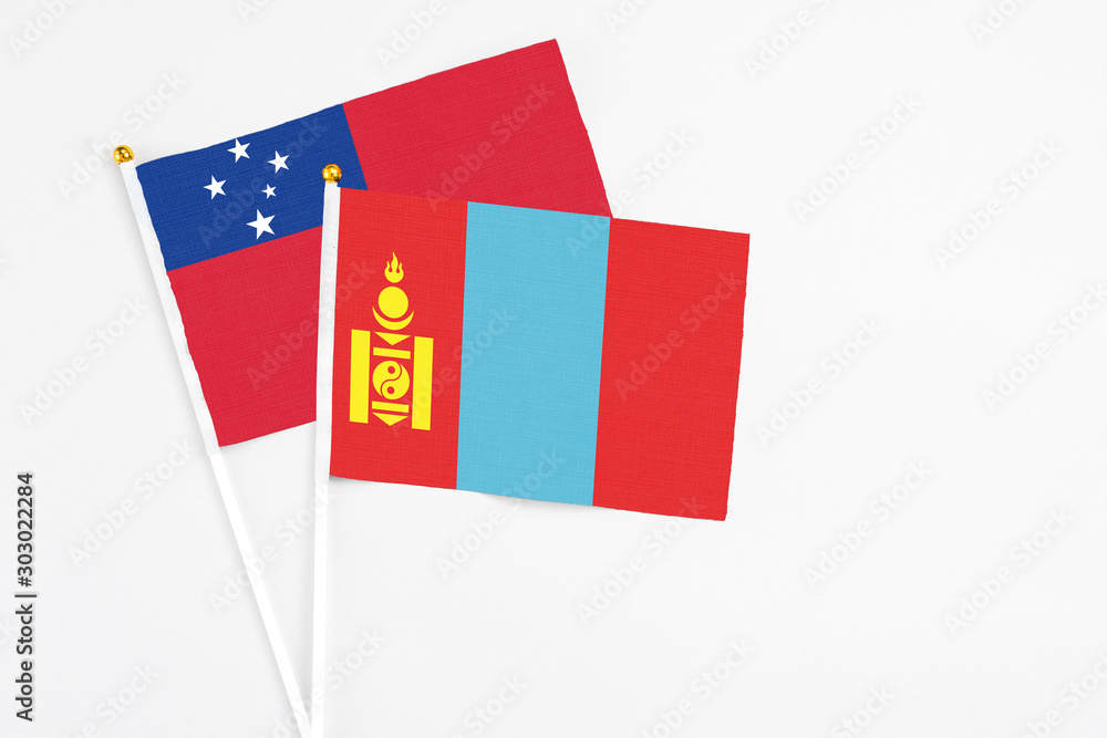Fototapeta premium Mongolia and Samoa stick flags on white background. High quality fabric, miniature national flag. Peaceful global concept.White floor for copy space.