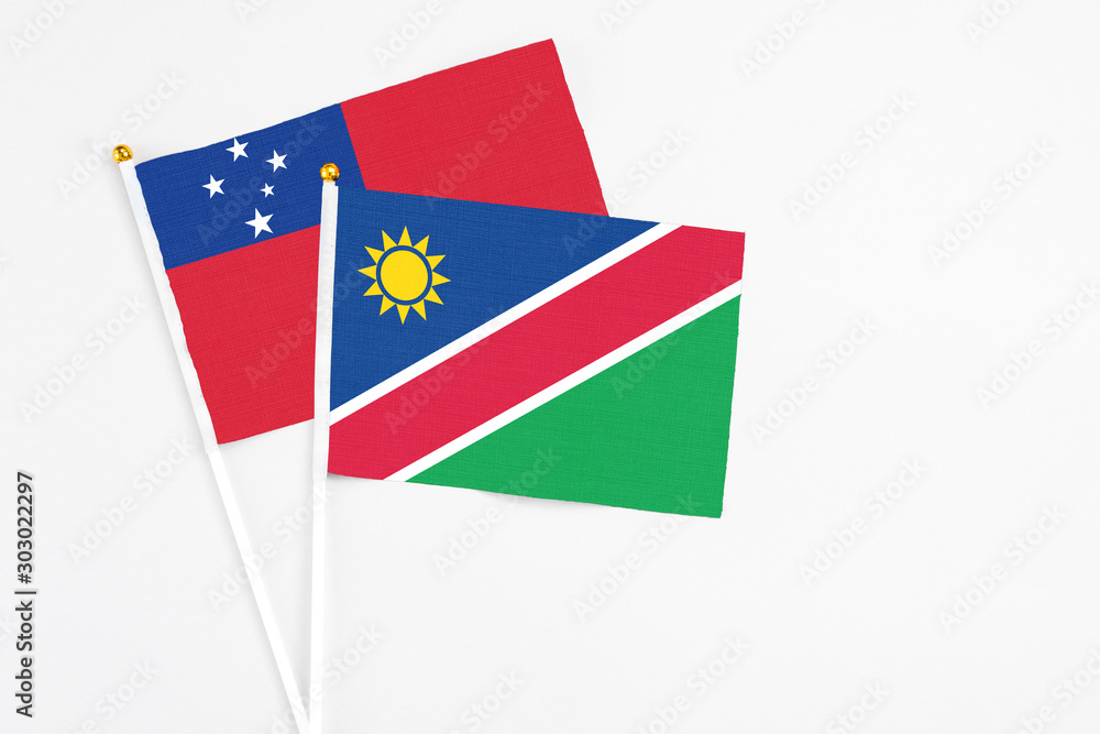 Namibia and Samoa stick flags on white background. High quality fabric, miniature national flag. Peaceful global concept.White floor for copy space. Namibia and Samoa stick flags on white background. High quality fabric, miniature national flag. Peaceful global concept.White floor for copy space.