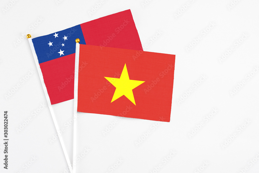Vietnam and Samoa stick flags on white background. High quality fabric, miniature national flag. Peaceful global concept.White floor for copy space. Vietnam and Samoa stick flags on white background. High quality fabric, miniature national flag. Peaceful global concept.White floor for copy space.