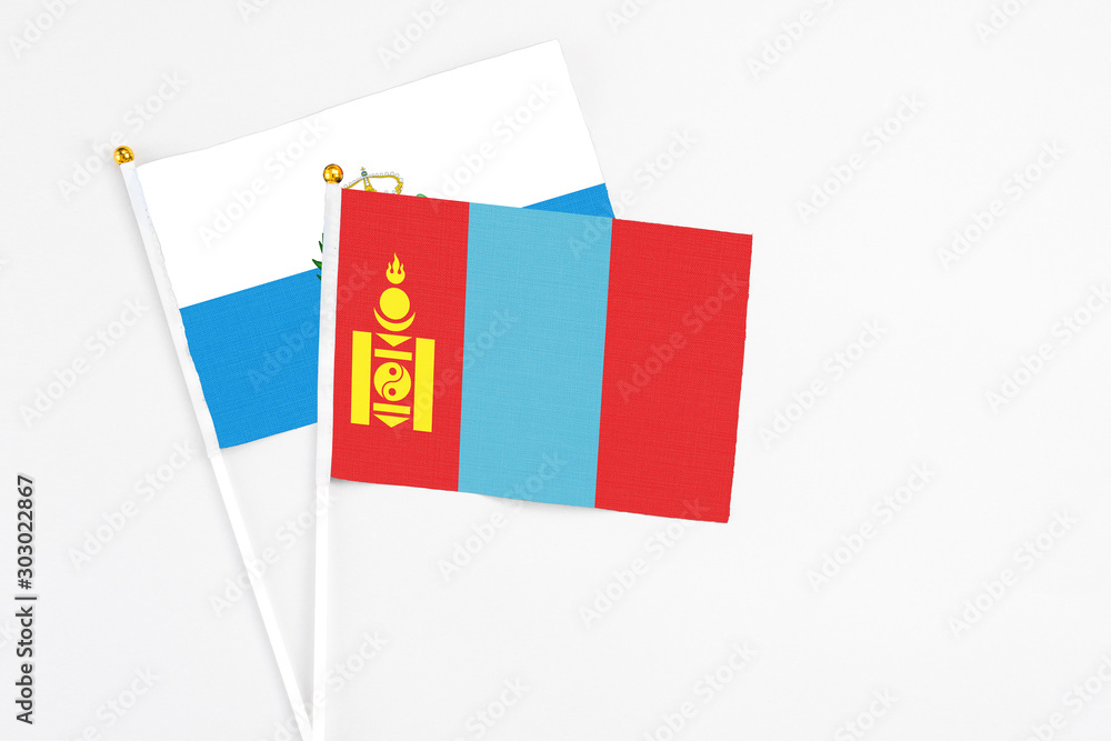 Fototapeta premium Mongolia and San Marino stick flags on white background. High quality fabric, miniature national flag. Peaceful global concept.White floor for copy space.