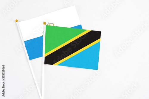Free Download Tanzania and San Marino stick flags on white background. High quality fabric, miniature national flag. Peaceful global concept.White floor for copy space. - GFXLoad