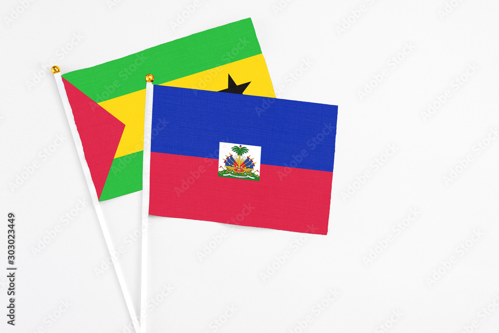 Haiti and Sao Tome And Principe stick flags on white background. High quality fabric, miniature national flag. Peaceful global concept.White floor for copy space. Haiti and Sao Tome And Principe stick flags on white background. High quality fabric, miniature national flag. Peaceful global concept.White floor for copy space.