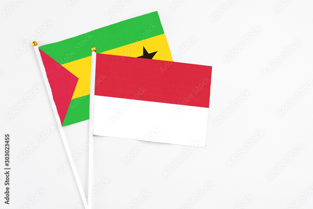 Indonesia and Sao Tome And Principe stick flags on white background. High quality fabric, miniature national flag. Peaceful global concept.White floor for copy space. Indonesia and Sao Tome And Principe stick flags on white background. High quality fabric, miniature national flag. Peaceful global concept.White floor for copy space.
