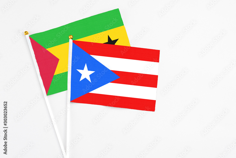 Puerto Rico and Sao Tome And Principe stick flags on white background. High quality fabric, miniature national flag. Peaceful global concept.White floor for copy space. Puerto Rico and Sao Tome And Principe stick flags on white background. High quality fabric, miniature national flag. Peaceful global concept.White floor for copy space.