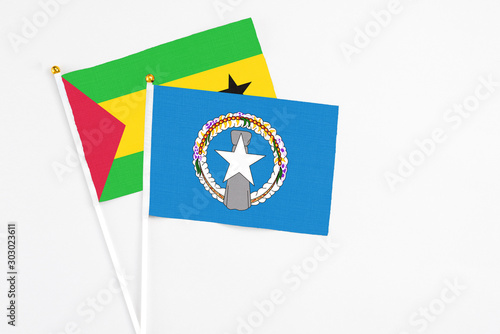 Free Download Northern Mariana Islands and Sao Tome And Principe stick flags on white background. High quality fabric, miniature national flag. Peaceful global concept.White floor for copy space. - GFXLoad