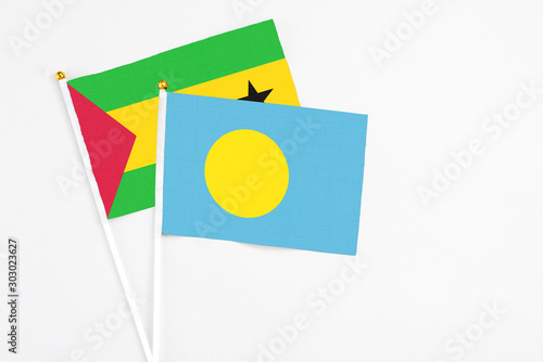Free Download Palau and Sao Tome And Principe stick flags on white background. High quality fabric, miniature national flag. Peaceful global concept.White floor for copy space. - GFXLoad