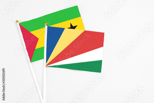Free Download Seychelles and Sao Tome And Principe stick flags on white background. High quality fabric, miniature national flag. Peaceful global concept.White floor for copy space. - GFXLoad