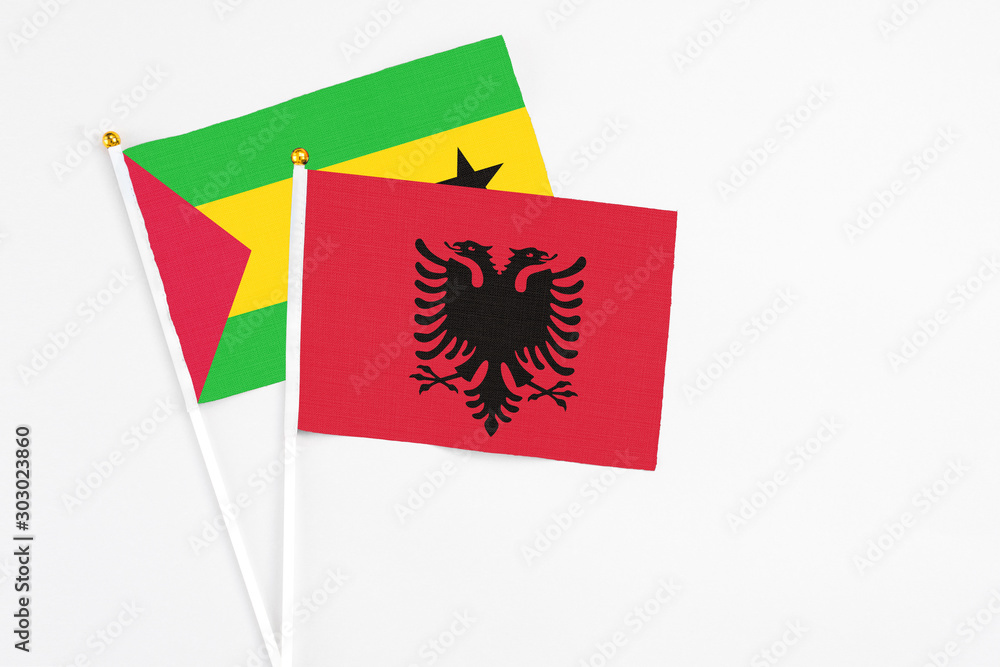Obraz premium Albania and Saudi Arabia stick flags on white background. High quality fabric, miniature national flag. Peaceful global concept.White floor for copy space.